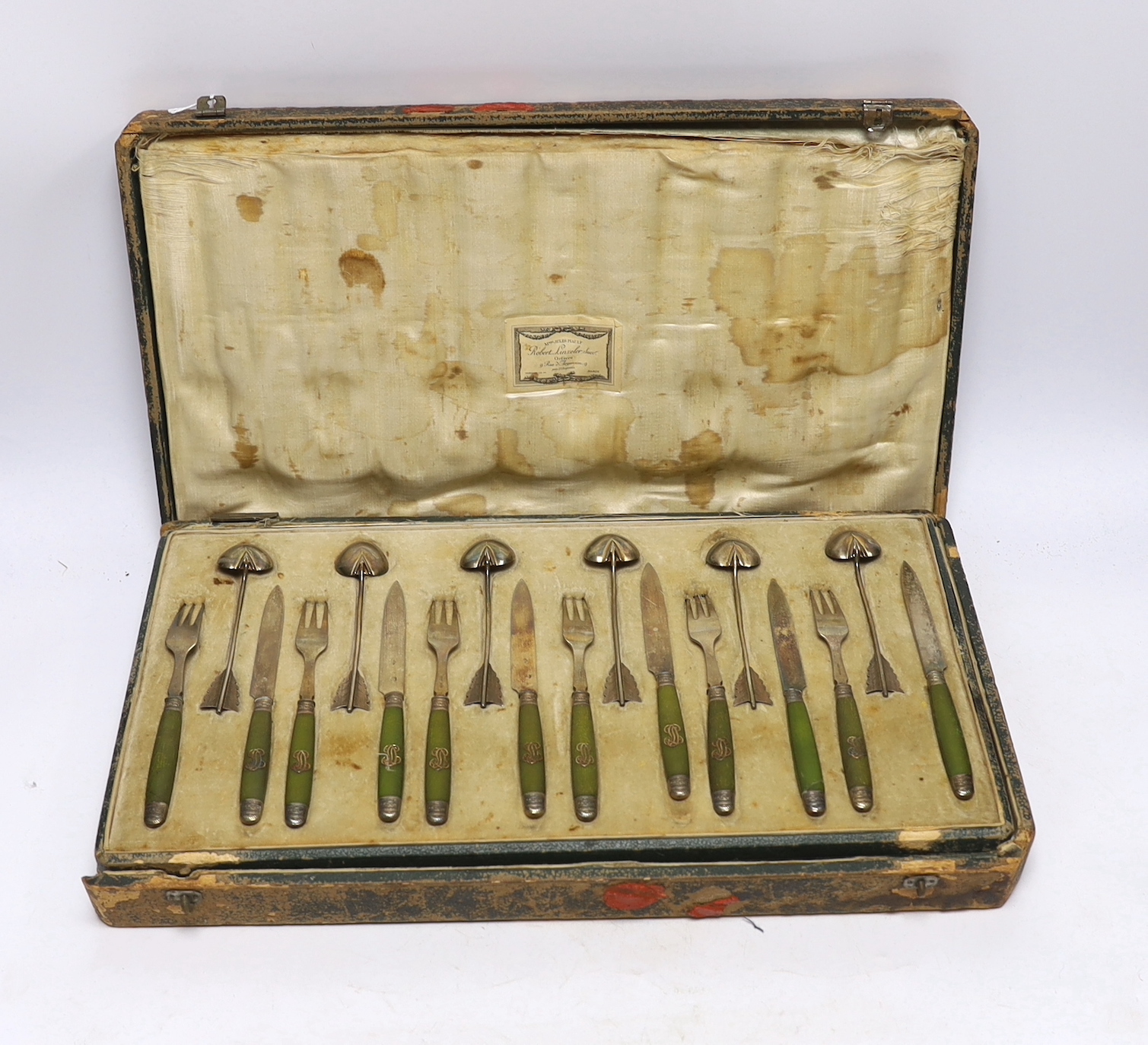 A cased French thirty six piece dessert set, comprising twelve white metal spoons and twelve pairs of phenolic handled white metal dessert eaters, all by Robert Linzeler, knife 15.5cm.